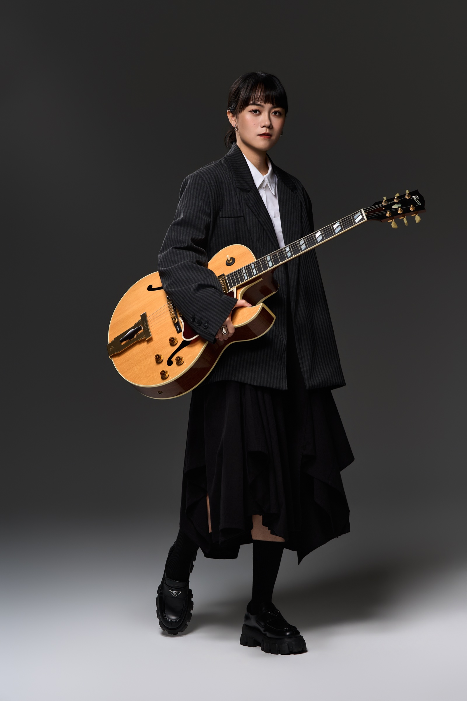 Ponpon Chen studio portrait with her guitar