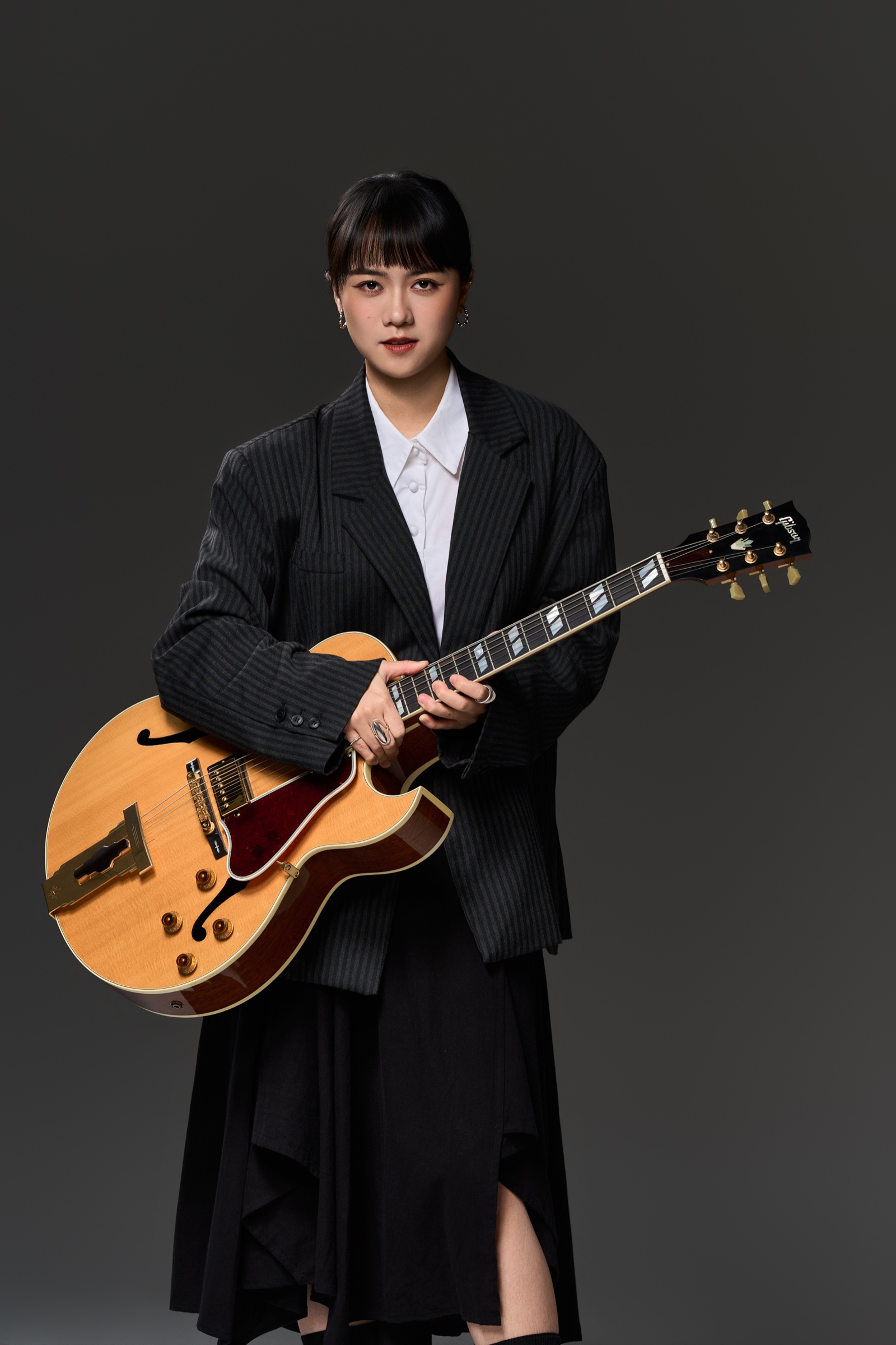 Ponpon Chen full-length studio portrait with her guitar